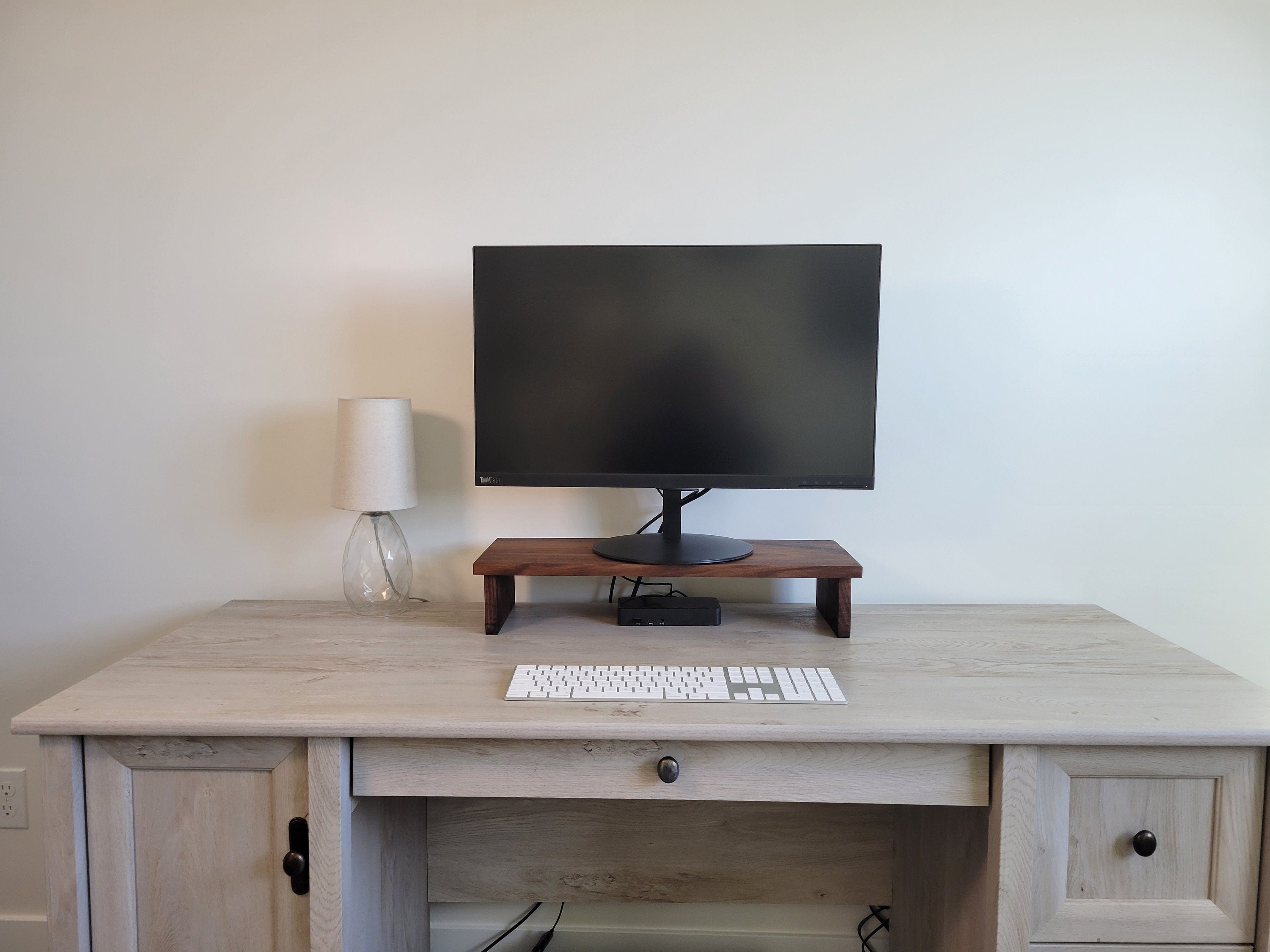 a desk with a computer monitor and keyboard on it